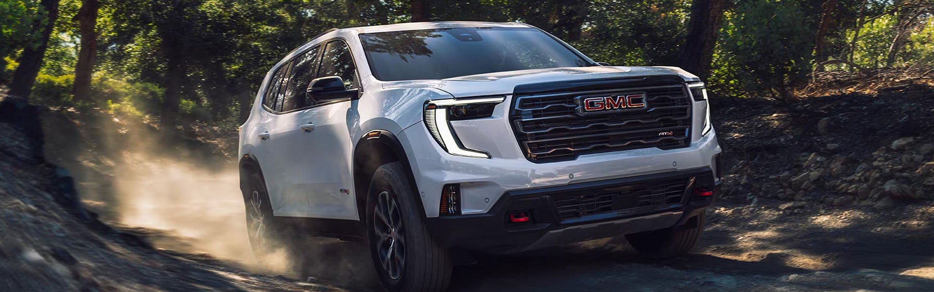 2026 GMC Acadia SUV in action on rugged forest trail